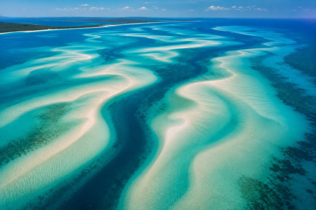 Aerial view of turquoise sandbars and deep Indian Ocean channels around the Bazaruto Archipelago in Mozambique, luxury honeym