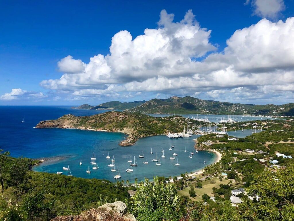 Aerial view of English Harbour Antigua with historic Nelson's Dockyard and sailing yachts moored in turquoise Caribbean water