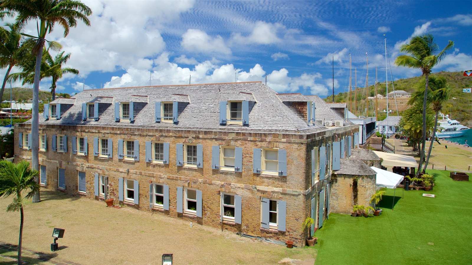 Historic Georgian dockyard buildings at Nelson's Dockyard in English Harbour Antigua with sailing yachts moored in turquoise water, Caribbean heritage honeymoon, editorial travel photography