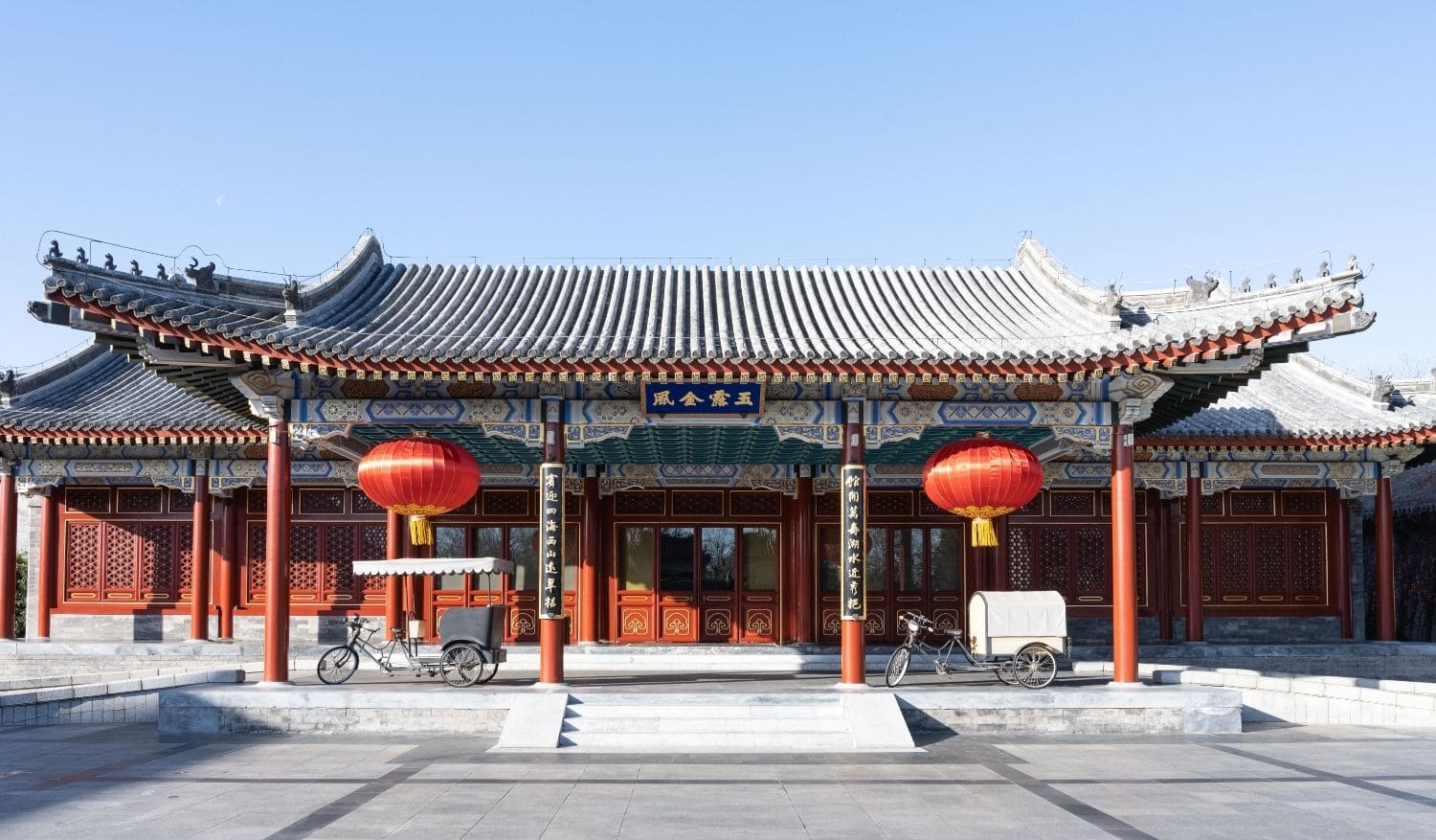 Aman Summer Palace Beijing traditional Chinese pavilion and courtyard with curved tile rooftops surrounded by mature trees in soft morning light, luxury heritage hotel, editorial photography