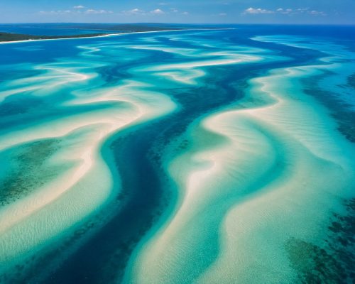 Aerial view of turquoise sandbars and deep Indian Ocean channels around the Bazaruto Archipelago in Mozambique, luxury honeym